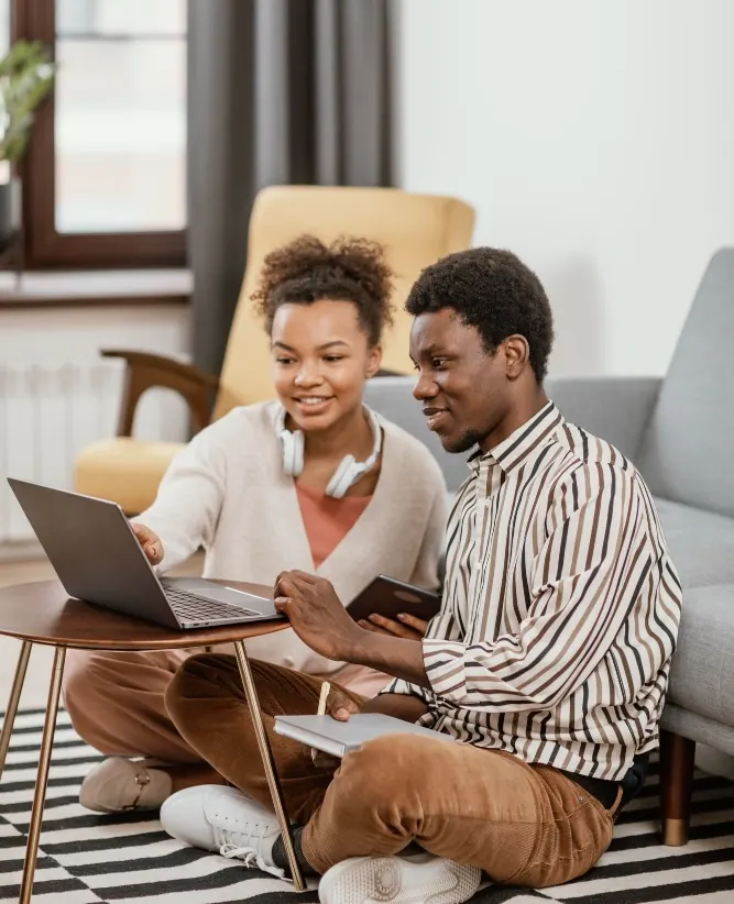 Two learners working through a lesson together on a laptop